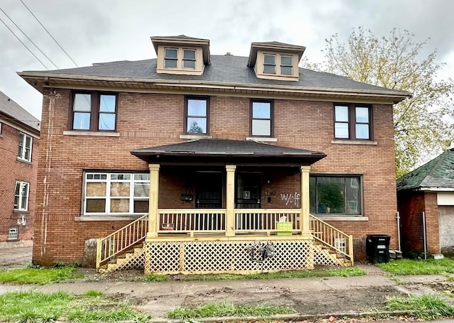 rear view of house featuring a porch