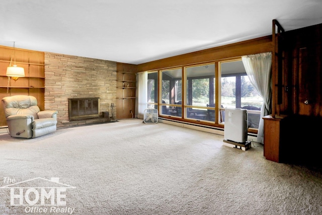 unfurnished living room with a baseboard radiator, a stone fireplace, carpet floors, and built in features