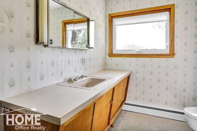 bathroom with a baseboard radiator, vanity, and toilet