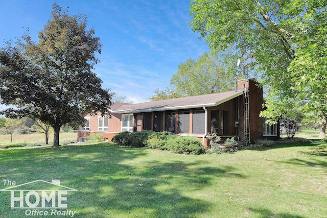 8102 Britton Rd, Perry, MI 48872 - exterior space featuring a sunroom, a chimney, and a lawn