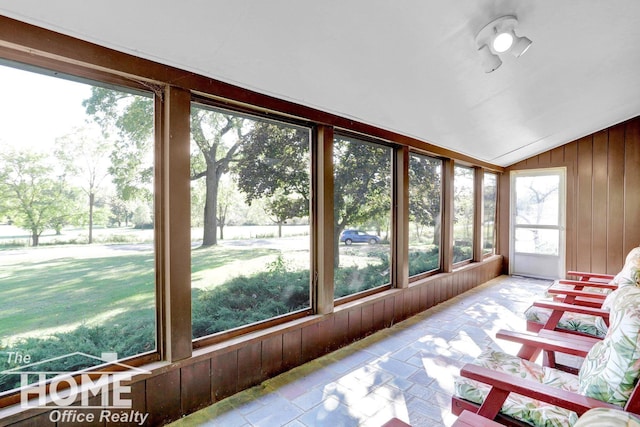 8102 Britton Rd, Perry, MI 48872 - sunroom / solarium with lofted ceiling, wood walls, and stone tile flooring