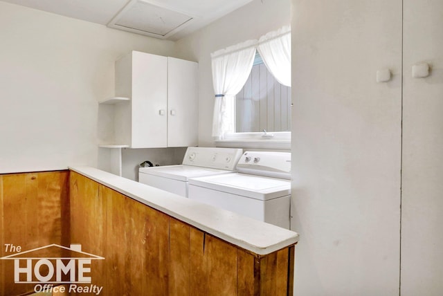 laundry area featuring separate washer and dryer and cabinets