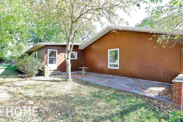 exterior space with entry steps and a patio