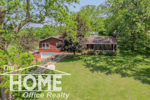 8102 Britton Rd, Perry, MI 48872 - view of front of property with an attached garage and a front yard