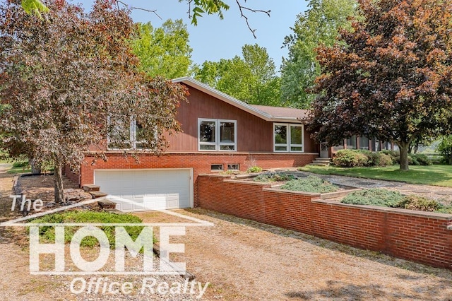 8102 Britton Rd, Perry, MI 48872 - view of front facade with dirt driveway, brick siding, and an attached garage