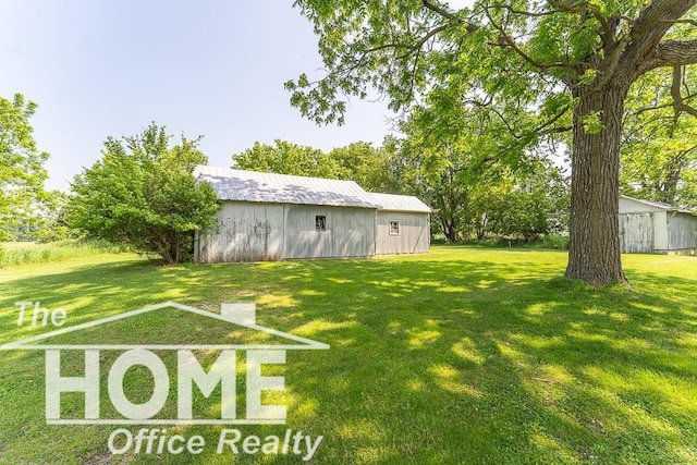 8102 Britton Rd, Perry, MI 48872 - view of grassy yard with a pole building and an outdoor structure