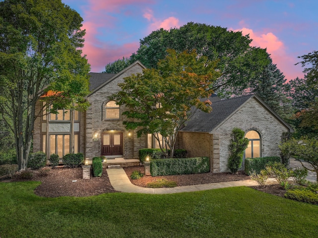 view of front of house featuring french doors and a lawn