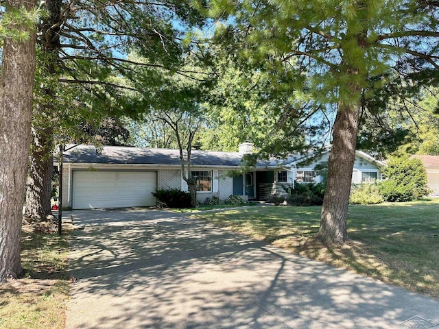 single story home with a garage and a front yard