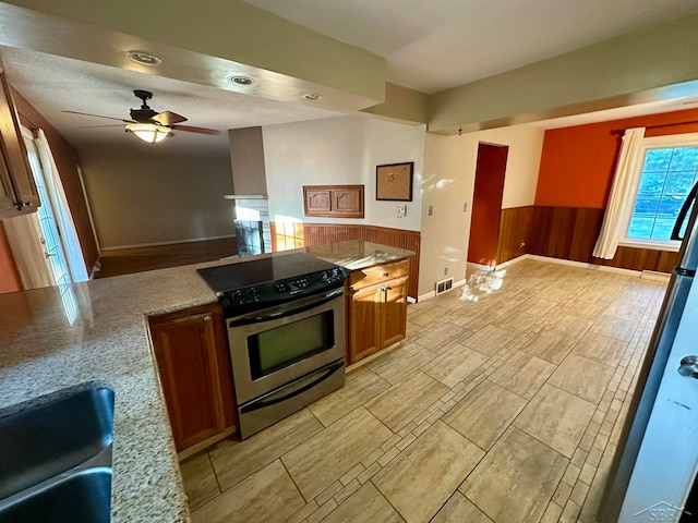 kitchen with ceiling fan, electric stove, and sink