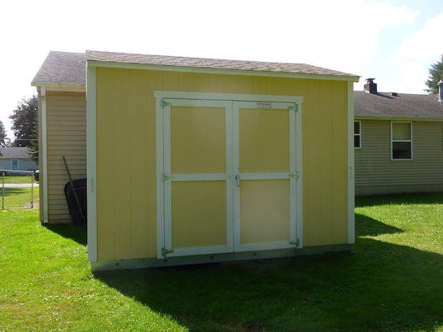 view of outbuilding with a lawn