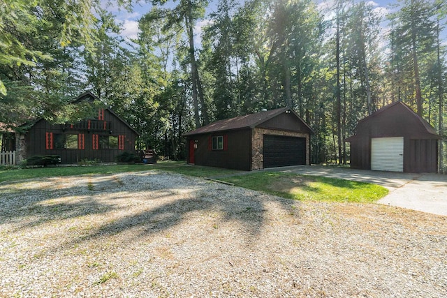 exterior space with a garage and a storage unit