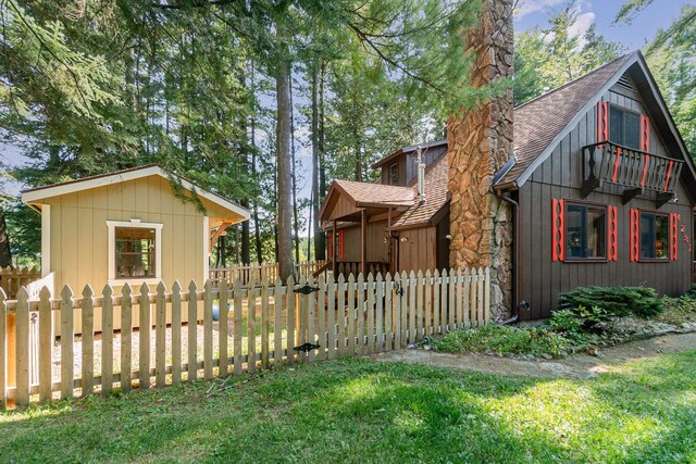4281 Franklin Trl, Sterling, MI 48659 - view of property exterior with a shingled roof, a gate, and a chimney