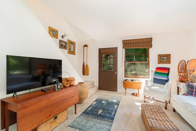 carpeted living room with lofted ceiling