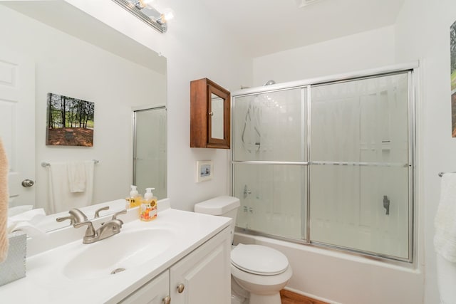 full bathroom with vanity, toilet, and enclosed tub / shower combo