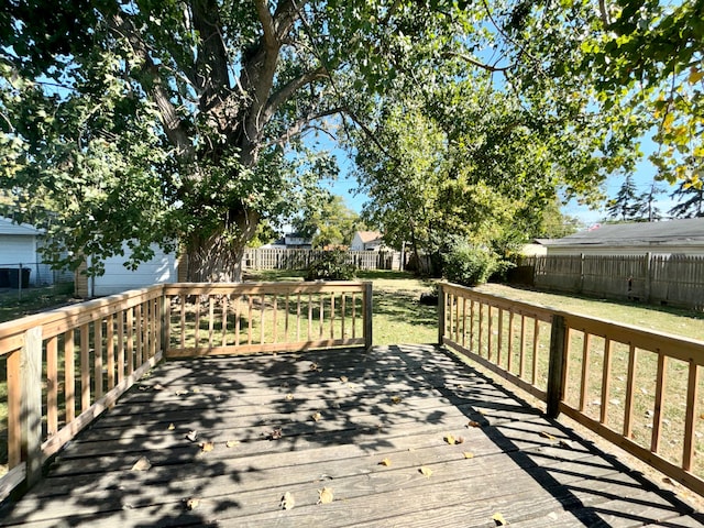 wooden deck featuring a yard