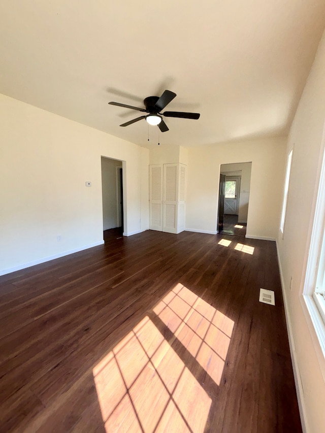 unfurnished room featuring ceiling fan and dark hardwood / wood-style floors