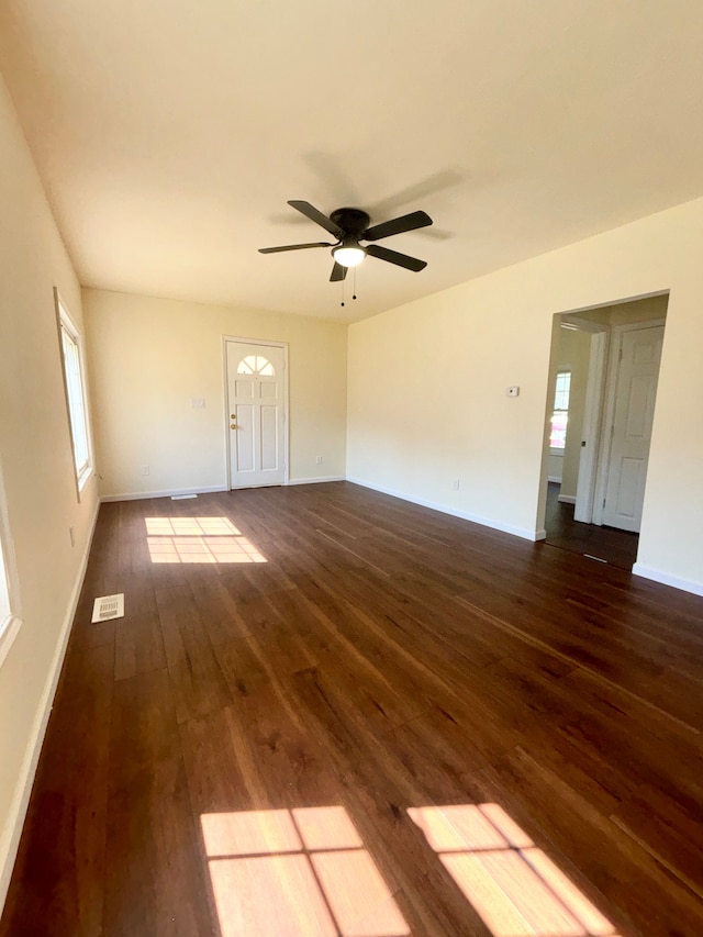 unfurnished room with dark hardwood / wood-style floors and ceiling fan