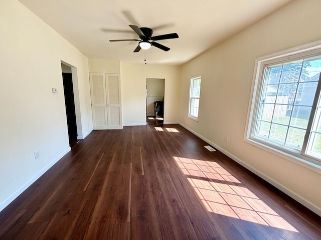 spare room with ceiling fan and dark wood-type flooring