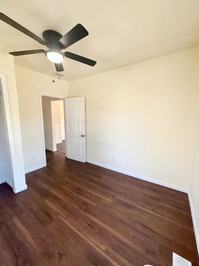 unfurnished room featuring ceiling fan and dark wood-type flooring