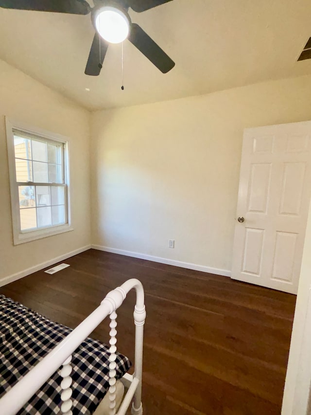 spare room featuring ceiling fan and dark hardwood / wood-style floors