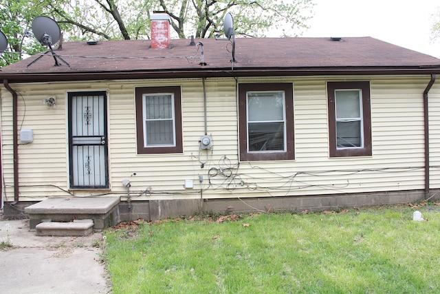 back of house with a yard