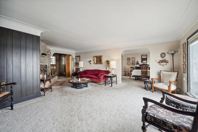 living room with carpet floors, a healthy amount of sunlight, and ornamental molding