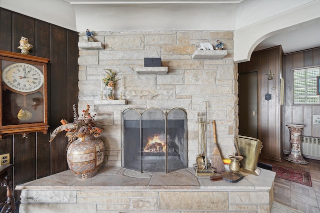 room details featuring parquet flooring, a fireplace, and wooden walls