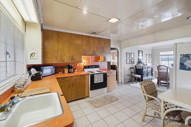 kitchen with electric range, sink, and light tile patterned floors