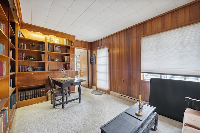 carpeted office featuring wooden walls