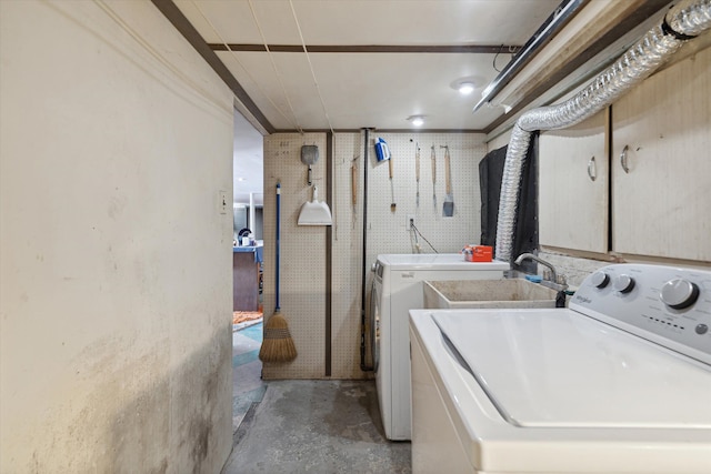 clothes washing area featuring independent washer and dryer