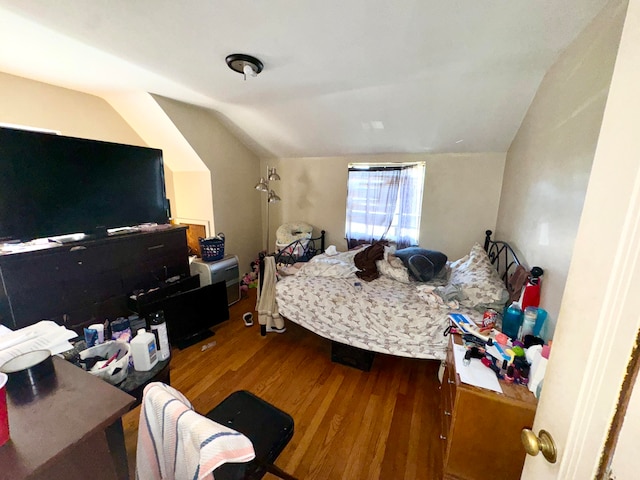 bedroom with hardwood / wood-style flooring and lofted ceiling