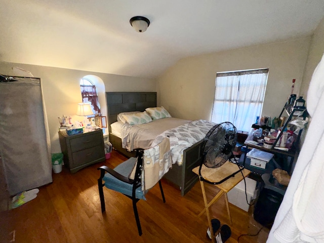 bedroom featuring wood-type flooring and vaulted ceiling