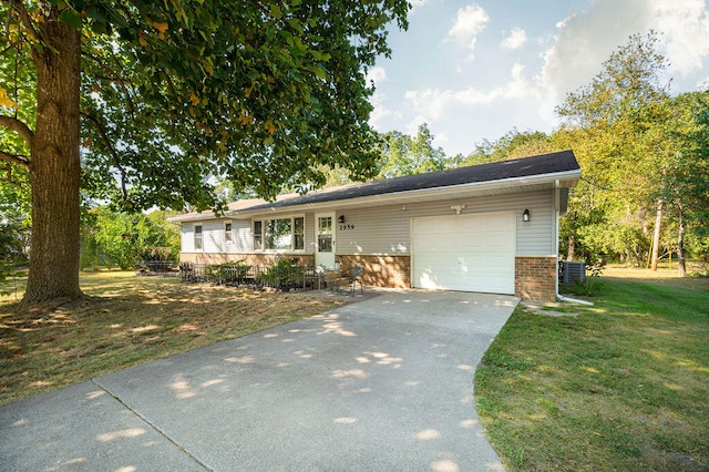 single story home with a garage and a front lawn