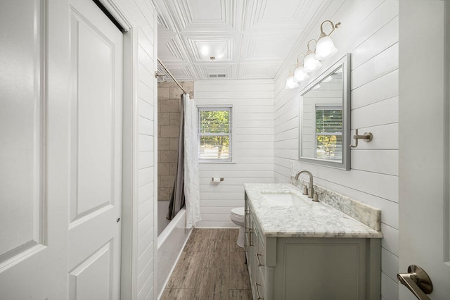 full bathroom featuring vanity, shower / bath combo, wooden walls, toilet, and wood-type flooring