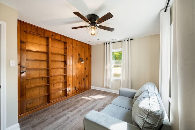 living area featuring ceiling fan and light hardwood / wood-style floors