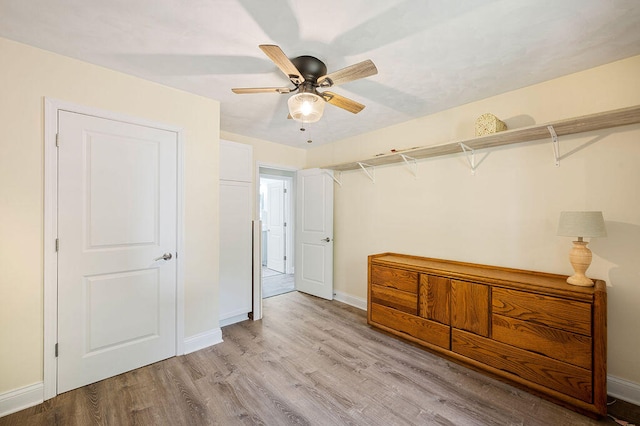 unfurnished bedroom with ceiling fan and light hardwood / wood-style flooring