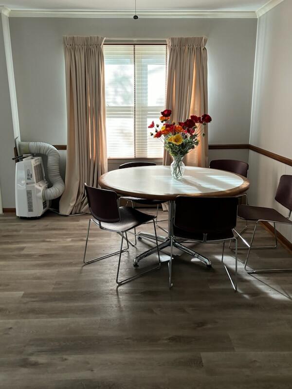 dining space with hardwood / wood-style flooring and ornamental molding