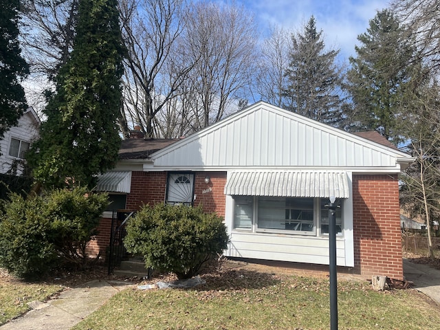 bungalow-style home with brick siding