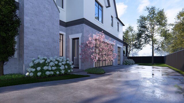 1183 Puritan Ave, Birmingham, MI 48009 - view of property exterior with driveway, a garage, stucco siding, and stone siding