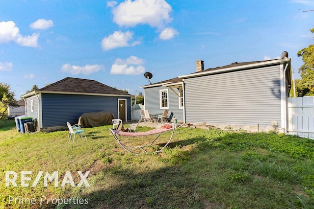 rear view of property featuring a patio area and a yard