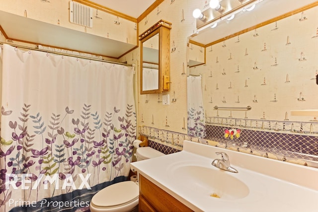 bathroom with vanity, toilet, and crown molding