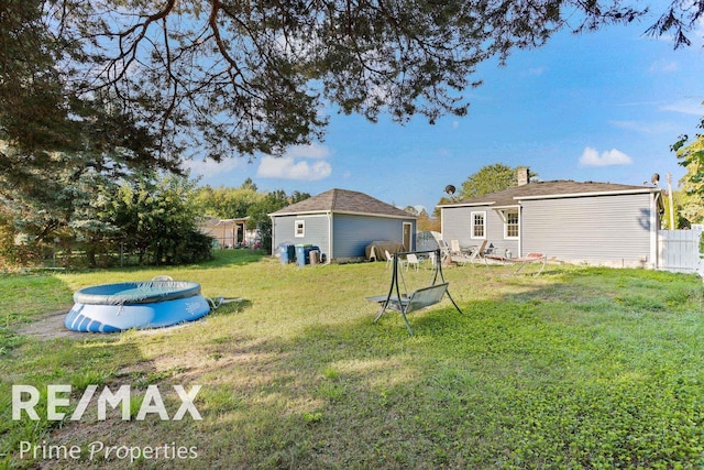 view of yard featuring a covered pool