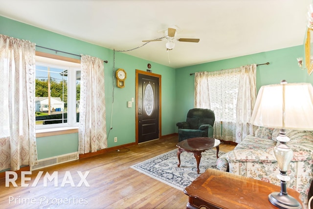 living room featuring hardwood / wood-style flooring and ceiling fan