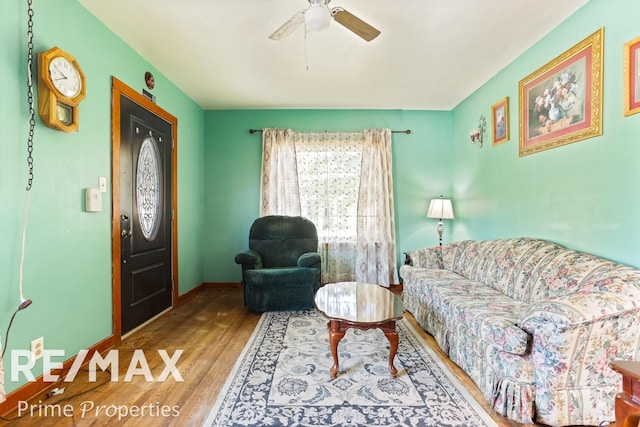 living room featuring ceiling fan and wood-type flooring