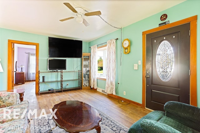 living room with ceiling fan and light hardwood / wood-style floors