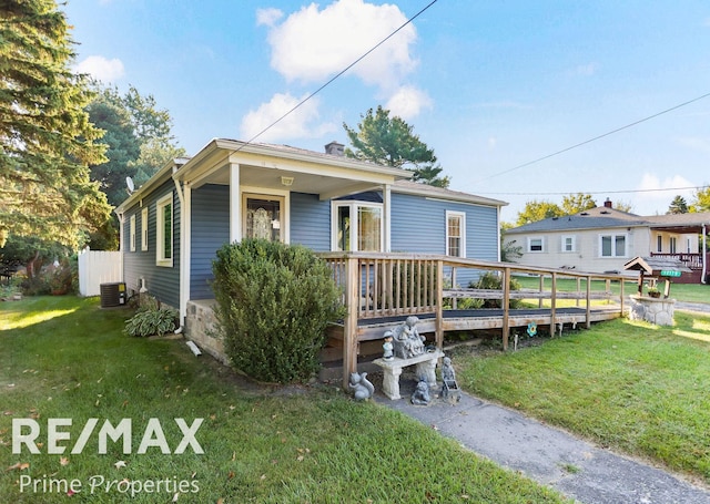 view of front of house with central AC unit, a deck, and a front lawn