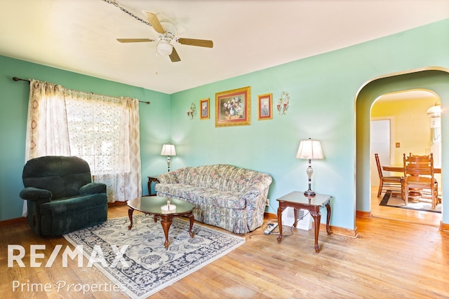 living room with ceiling fan and light hardwood / wood-style flooring