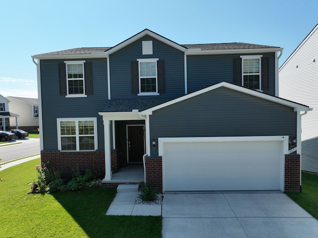 view of front of house with a front yard and a garage