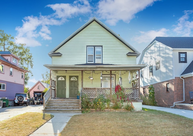 bungalow-style house featuring a front lawn and covered porch