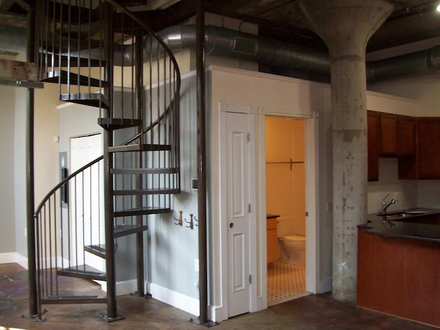 stairway featuring sink